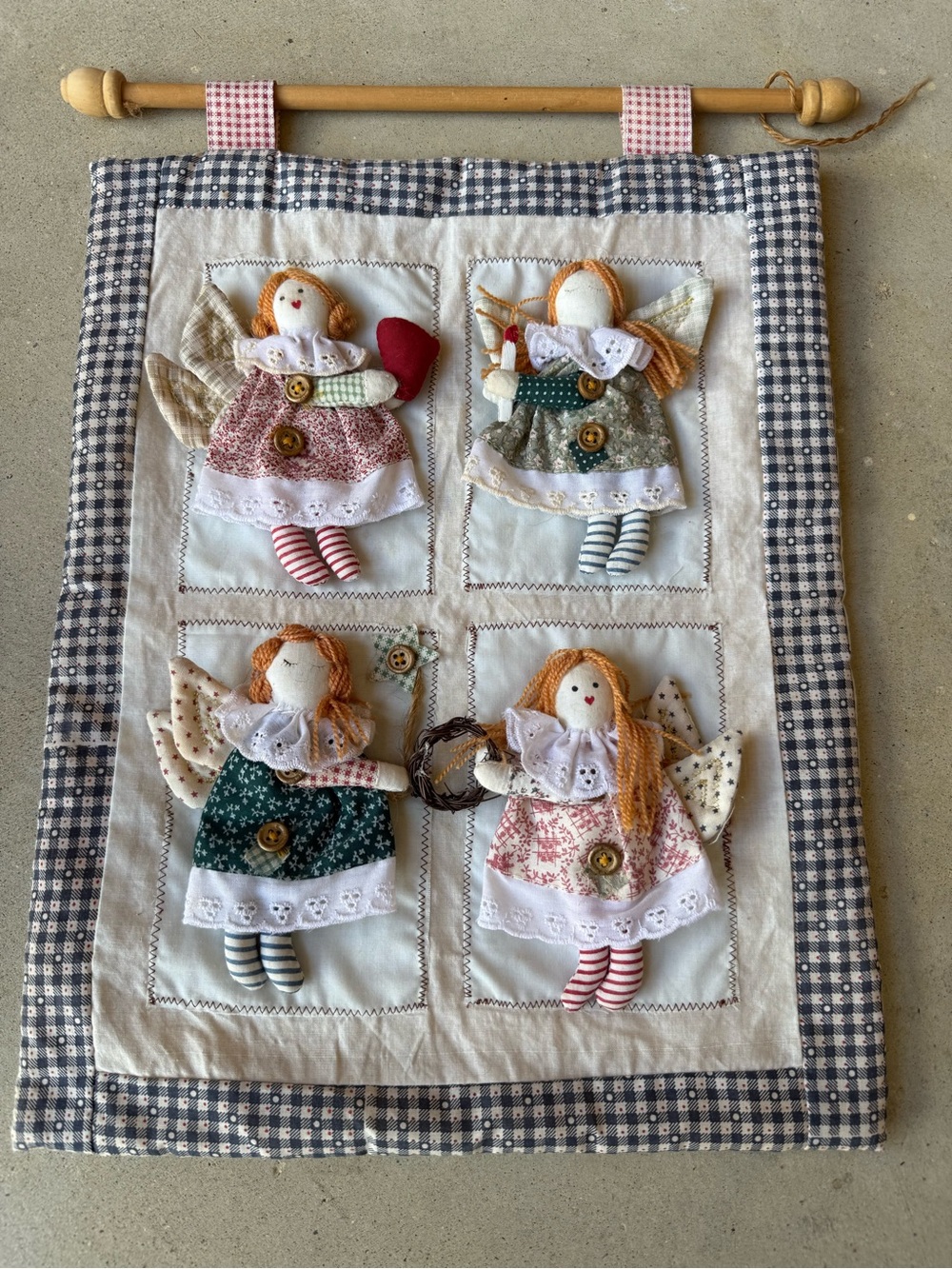 Christmas wall hanging featuring 4 cloth angels adorned with buttons